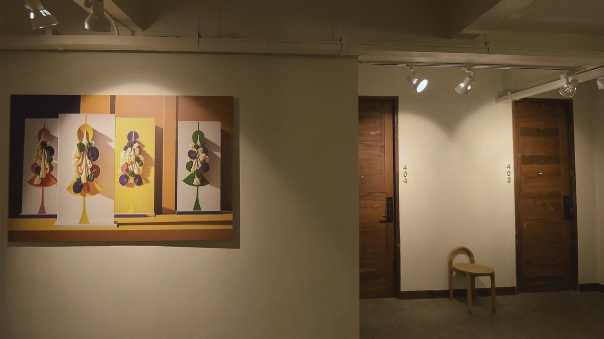 Corridor with paintings and teak doors in warm light