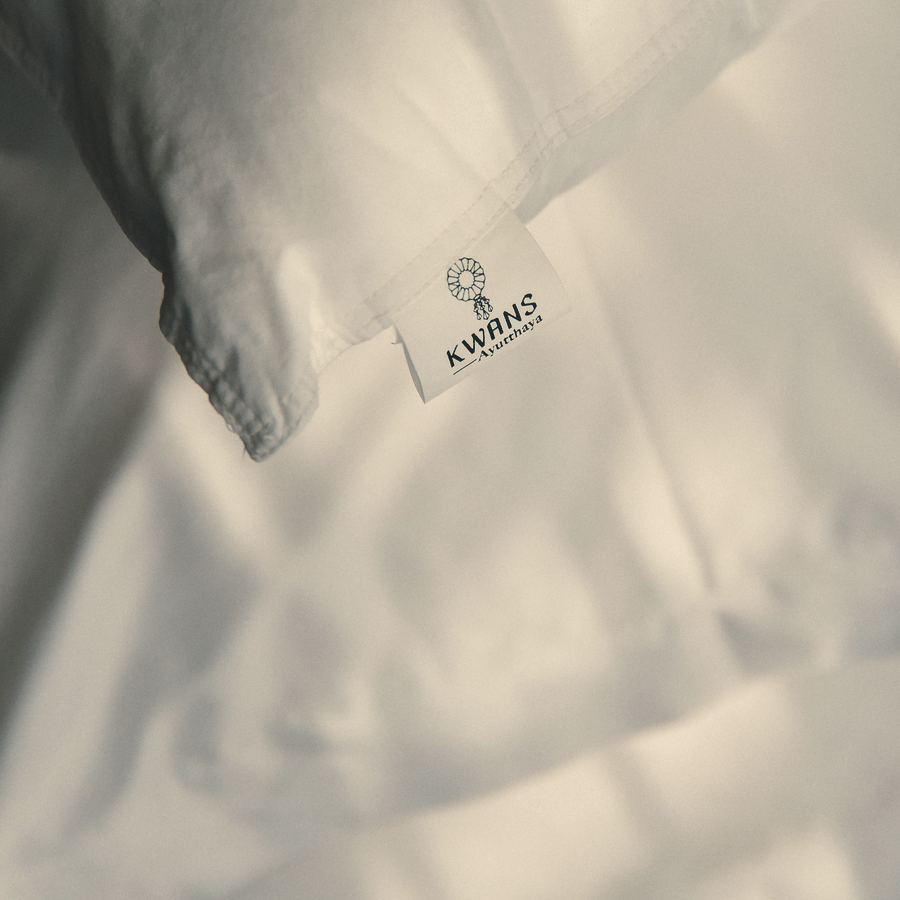KWANS label on a white satin-cotton pillowcase